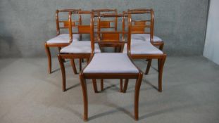 A set of six Recency style yew wood dining chairs, with a turned and wrythen top rail, over drop