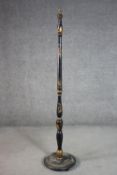 A circa 1920s Chinoiserie standard lamp, black lacquered and parcel gilt, with a turned stem on a