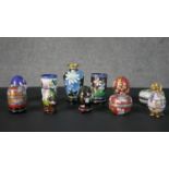 A collection of Chinese cloisonne enamel boxes and vases, each with a different floral design,