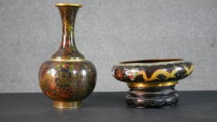 A Japanese cloisonné enamel floral design brass vase along with a dragon design bowl on carved and