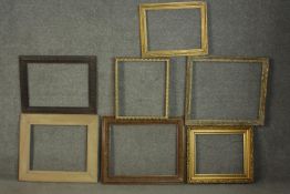 A collection of seven picture frames, including five giltwood frames and a carved oak frame. H.70.