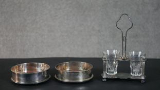 Two oak and silver plated wine coasters along with a silver plated Christofle, Paris salt cellar.