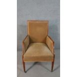 An Edwardian mahogany armchair, upholstered in brown velour, on square section tapering legs.