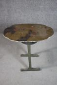 A circa 1920s Chinoiserie green painted folding table, the nearly oval top painted with figures,