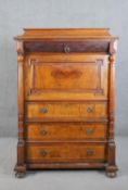 A late 19th century French figured walnut secretaire à àbattant, with a carved drawer over a fall