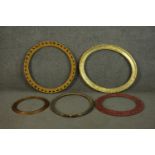 A collection of five circular and oval picture frames, some gilded, one red. H.60 W.50cm. (largest)