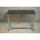 A modernist side table, with a rectangular smoked glass top on a chromed steel base. H.71 W.99 D.