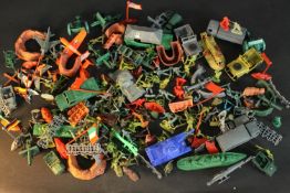 A large collection of vintage plastic military toys, including soldiers, tanks and other items. H.26