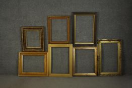 A collection of seven picture frames, including four giltwood and gesso frames, some with floral and