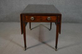 A 19th century mahogany Pembroke table, the top with drop leaves and a moulded edge, over two end