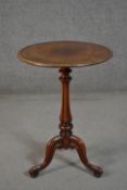 A Victorian walnut tripod wine table, with a circular dished top, on a lobed and turned stem, with