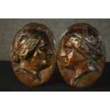 Two 19th century papier mache classical style bust relief wall plaques. H.21 W.23cm each.