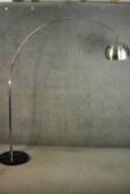 An Arco style adjustable lamp, with an aluminium shade and arm, on a circular black marble base. H.