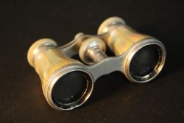 A leather cased pair of mother of pearl inlaid Leica opera glasses. L.11 W.7 D.4cm.