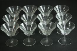 A set of twelve hand cut crystal martini glasses. H.11 Dia.10cm.