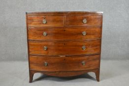 A George III mahogany bow front chest, of two short over three long graduated drawers, above a