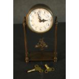 An early 20th century French gilt metal mantle clock with white enamel dial with rose swag