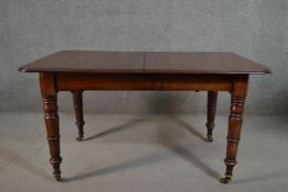 A Victorian mahogany extending dining table, the rectangular top with a moulded edge and rounded