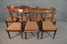 A harlequin set of seven Victorian mahogany bar back dining chairs, formed from a set of four and