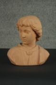 A 19th century style terracotta bust of a young boy, unsigned. H.30 W.27 D.14cm.