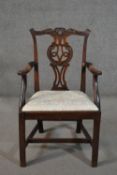 An 18th century mahogany open armchair, with a pierced splat back, carved with scrolling acanthus