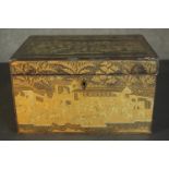 A Japanese Meiji period black lacquered box, gilded allover with detailed scenes depicting people
