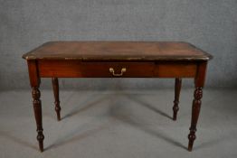 A late Victorian mahogany writing table, with a tooled brown leather writing insert, over a single