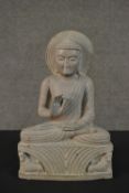 A carved Oriental hardstone Buddha in the lotus position. H.33.5 W.22 D.8cm