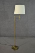 A 20th century brushed brass floor lamp with swing arm and cream shade. H.157cm