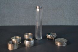 A collection of silver, including four silver napkin rings, a silver lidded jar and a repousse white