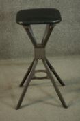 An early to mid 20th century steel industrial stool, with Mulberry leather seat, raised on four