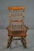 A rustic rocking chair, with turned spindle back, with elm bobbin turned arms, and an elm seat, on
