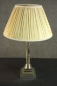 A silver plated Corinthian column candlestick, converted to a table lamp, with a square step-down