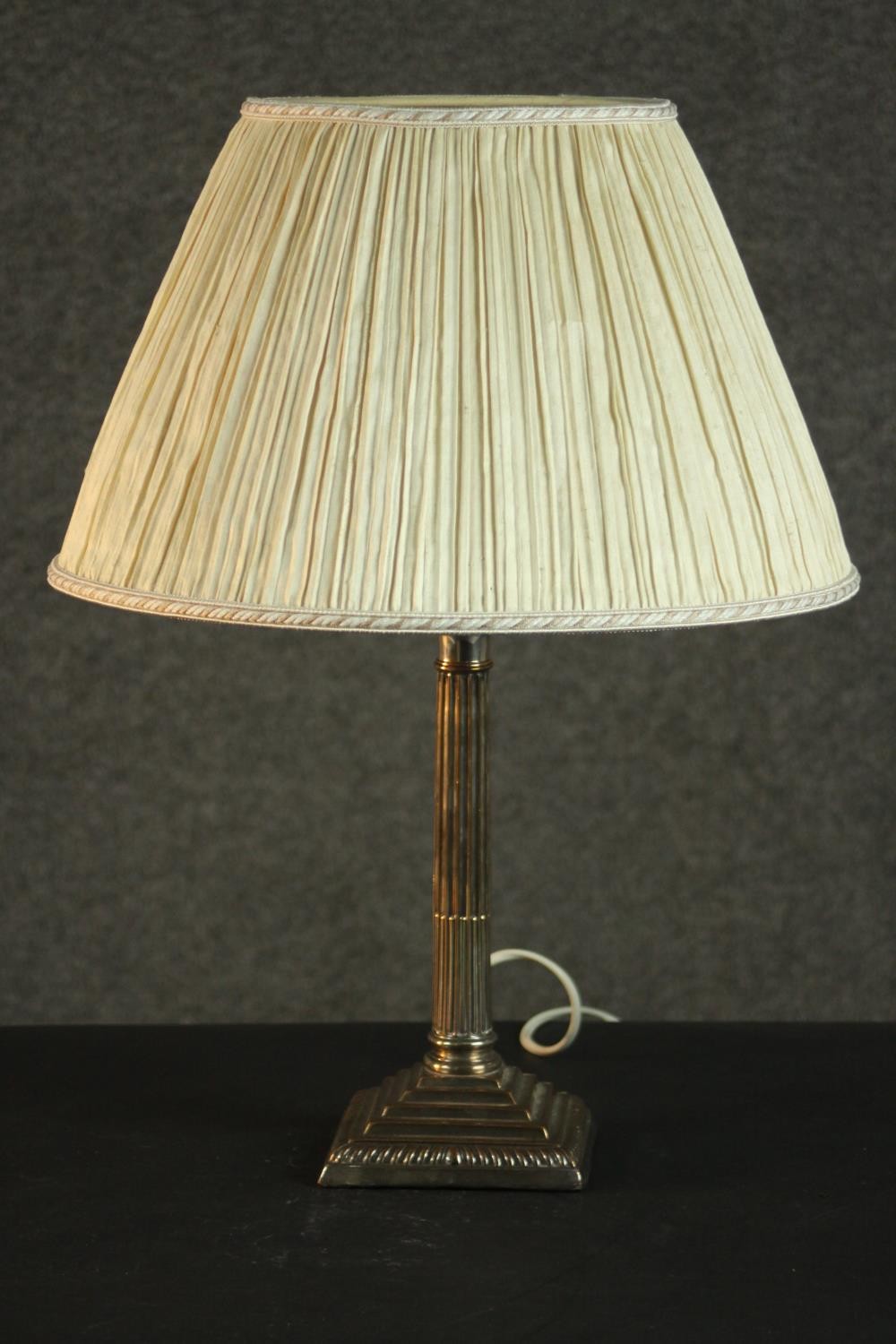 A silver plated Classical column candlestick, converted to a table lamp, with a square step-down
