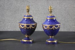 A pair of Sevres style porcelain table lamps, with a mottled cobalt blue body, decorated with gilt