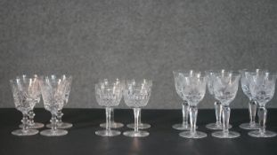 A collection of fourteen cut crystal glasses, including a set of four hand cut Edinburgh crystal