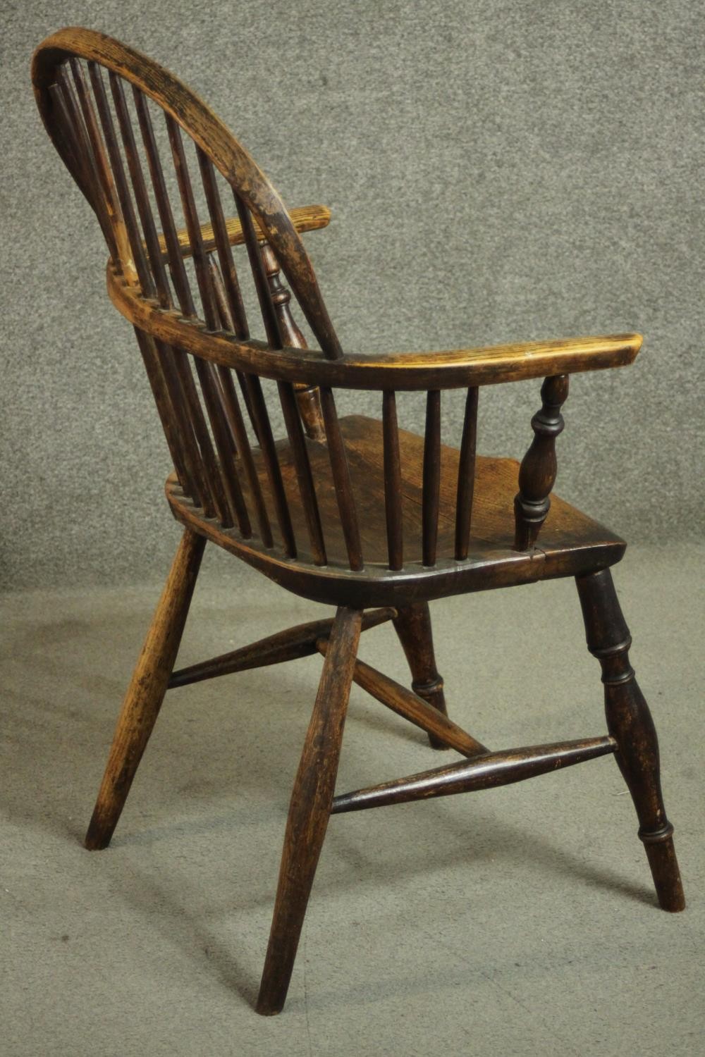 A 19th century ash hoop back Windsor armchair, with an elm seat, on turned legs joined by an H - Image 3 of 6