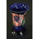 A Moorcroft vase, anemone pattern on dark blue ground, stamped Moorcroft, made in England. H.11