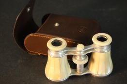 A leather cased pair of mother of pearl inlaid Leica opera glasses. L.11 W.7 D.4cm. Condition: