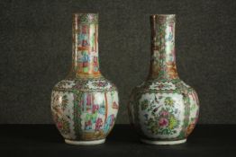 A pair of 19th century hand painted Famille rose porcelain vases with temple scenes and floral