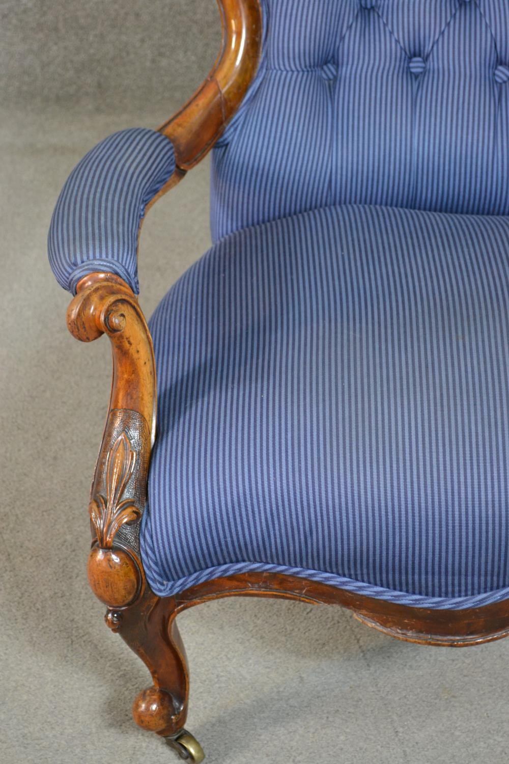 A Victorian walnut spoon back open armchair, upholstered in striped blue fabric, to the arms, seat - Image 6 of 7