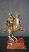 A gilt and silvered bronze of a man on horse back with turban and sword, indistinctly signed to