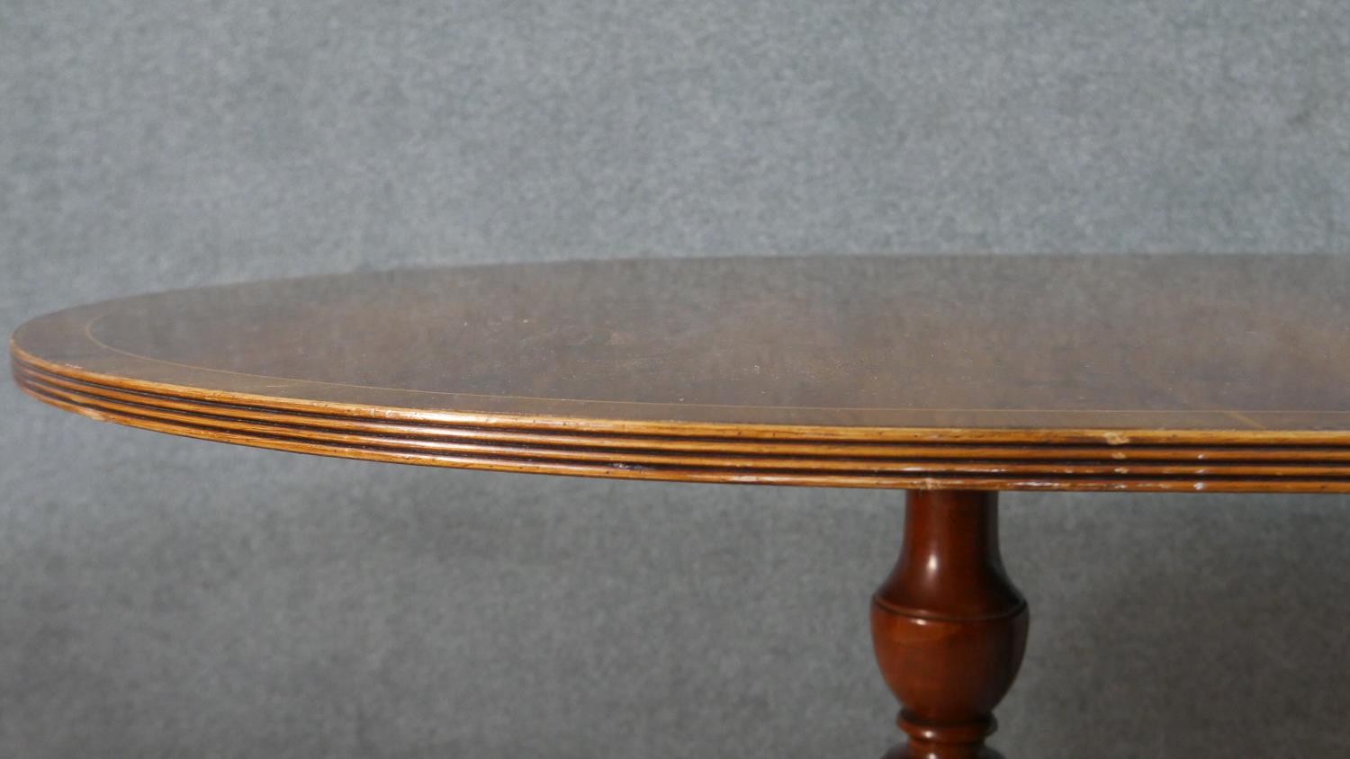 A George III style yew wood D-end dining table, with a cross banded top and additional leaf, on - Image 7 of 9