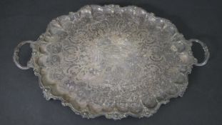 A large 19th century engraved pattern silver plate tray with relief foliate design to the border and