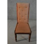 A George III mahogany side chair, with a buttoned back, upholstered in brown fabric, on turned legs.