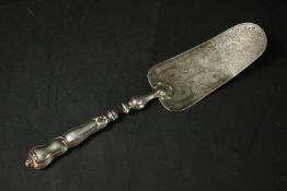 A Victorian silver plated engraved cake server with stylised foliate and floral design. L.30 W.6cm.