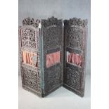 An ornately carved and pierced wood screen, possibly Burmese, of three folds, each with two panels