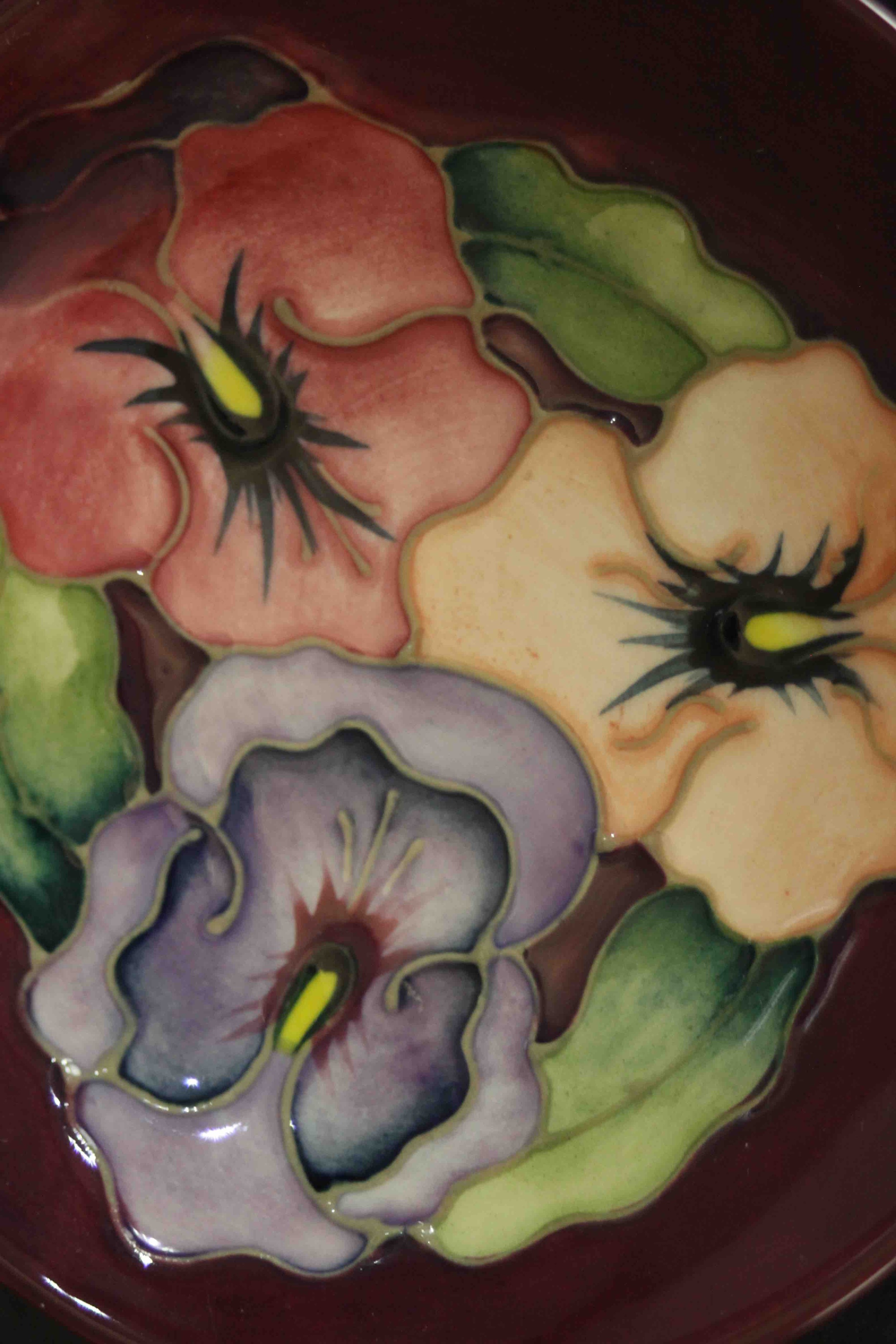 Three Moorcroft pottery dishes. Pansy and bird and fruit pattern, makers mark to the base. Dia.12cm. - Image 4 of 6