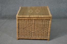 A 20th century wicker laundry basket, of cube form, with two lozenge designs to the lid, and one