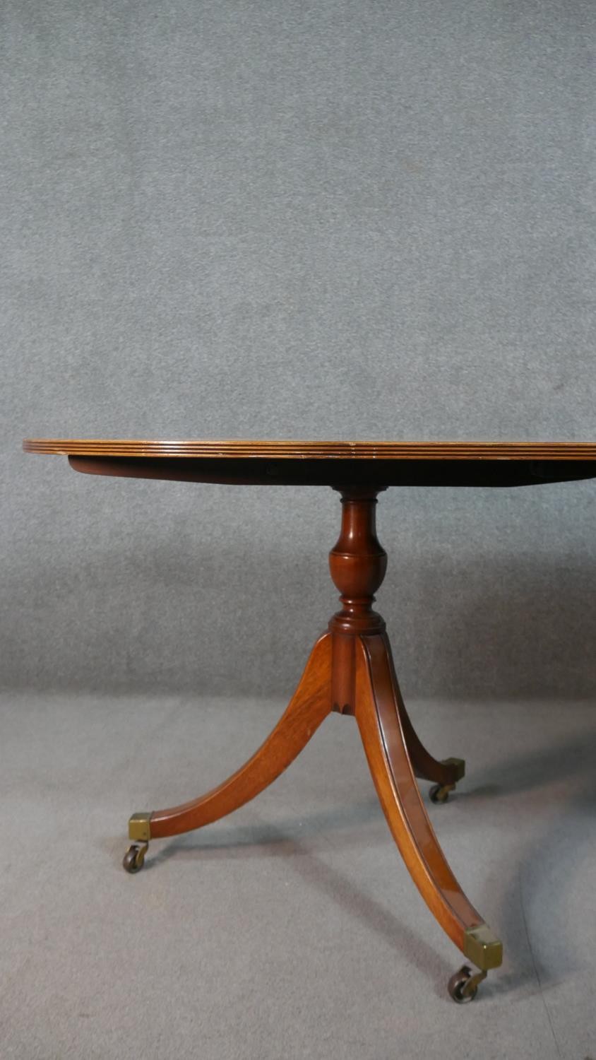 A George III style yew wood D-end dining table, with a cross banded top and additional leaf, on - Image 5 of 9
